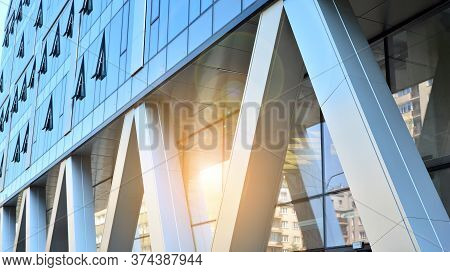 Combination Of Metal And Glass Wall Material. Steel Facade On Columns. Abstract Modern Architecture.