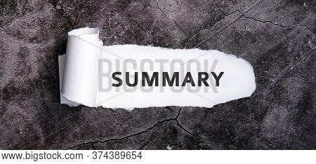 Summary With Torn White Paper On A Gray Concrete Table