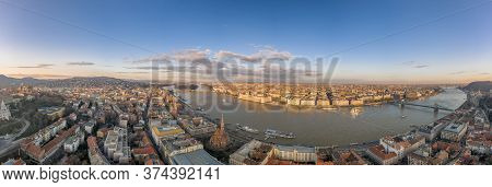 Wide Panorama Aerial Drone View Of Parliament By Danube River In Budapest Sunset