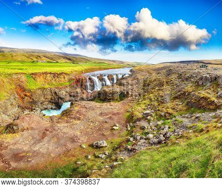 Captivating View Of  Kolufossar Waterfall At Summer Sunny Day.  Popular Tourist Travel Destination I