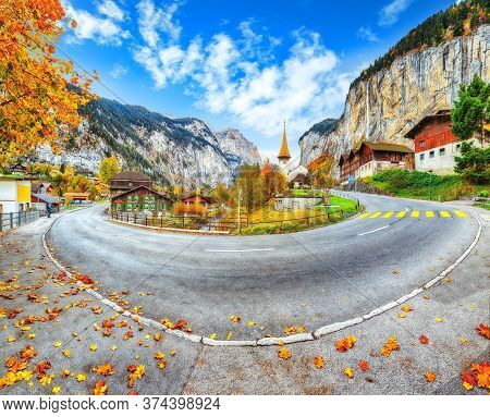 Gorgeous Autumn Landscape Of  Alpine Village Lauterbrunnen With Famous Church And Staubbach Waterfal