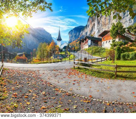 Gorgeous Autumn Landscape Of  Alpine Village Lauterbrunnen With Famous Church And Staubbach Waterfal