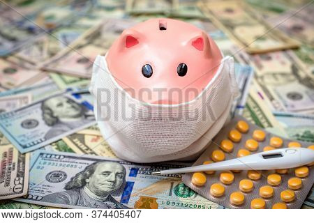 Piggy Bank In A Mask On A Background Of American Currency.the Concept Of Coronavrius Epidemic