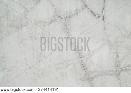 Cracked Concrete Wall Covered With Gray Cement Surface As Background