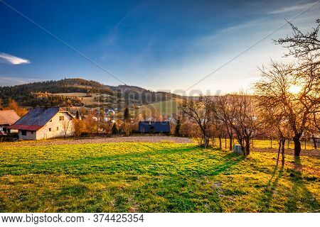Rural Landscape At Sunset. Country Houses With Gardens In A Village In The Kysuce Region Of Northwes