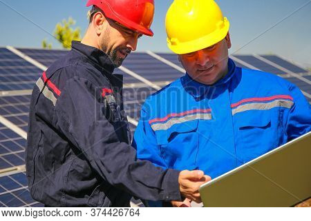 Green Energy, Power Plant And Two Tehnicians With Laptop