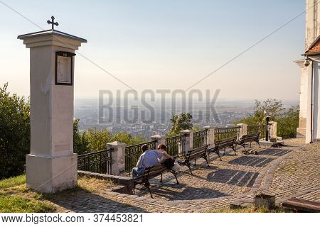 Vrsac, Serbia - October 1, 2016: Old Couple, Senior Lovers, Sitting And Looking At The Aerial Panora