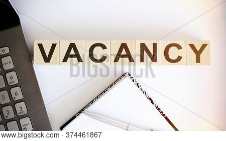 Business Concept Text On Wood Block Vacancy With Laptor And Notebook