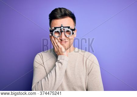 Young handsome caucasian man wearing optometrical glasses over purple background thinking looking tired and bored with depression problems with crossed arms.