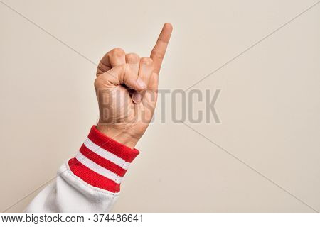 Hand of caucasian young man showing fingers over isolated white background showing little finger as pinky promise commitment, number one