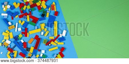 Vilnius, Lithuania - February 23, 2019. Colorful Lego Blocks On Light Blue And Green Blackground. To