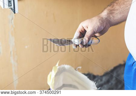 Hand With Putty Knife Repair Wall, Hand With A Spatula, Spatula With Spackle Paste Structure, Proces