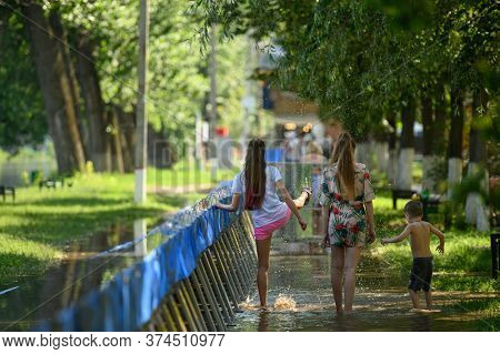 Vadul lui Voda, Criuleni, Moldova, June 2020: People play with water leaked through barriers set to prevent flood caused by Dniester river spill after heavy rains in Vadul lui Voda beach area