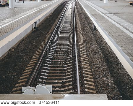 View Of The Railway Rails And Sleepers And High Side Platforms. Long-distance Rails