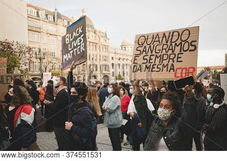 Porto, Portugal - June 6, 2020: Crowd Of Portugues People With Anti-racists Posters And Placards Dur