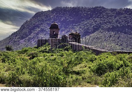 Rajasthan, India - October 06, 2012: A Landscape Of Hilly Mountains Surrounding Abandoned Cursed Rui