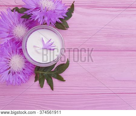 Cream Cosmetic Flower On Wooden Background\n Decoration