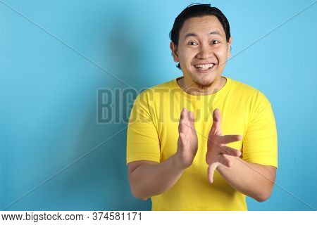 Young Asian Man Wearing White Shirt, Happy Proud Clapping Gesture.over Grey Background, Halfl Body P