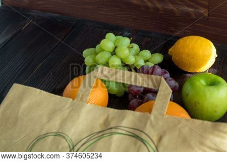Fruits In A Paper Bag. Orange, Lemon, Apple, Grapefruit, Grapes