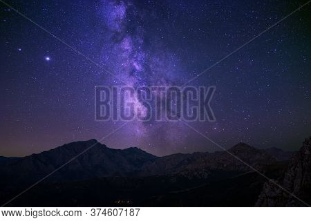 Milky Way Passing Over The Church In The Village Of Pioggiola And The Peaks Of Monte Padru And Monte