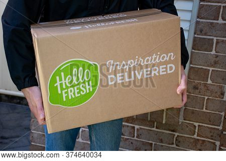 Sydney, Australia 2020-05-09 Delivery Man Holding Hello Fresh Meal Kits In A Box Near The Front Door