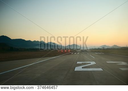 Airport Runway At Dawn. Travel, Air Transport, Aeronautical Industry Concept.