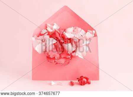 Red Envelope Full Of Flowers  Over A Pink Background Close Up