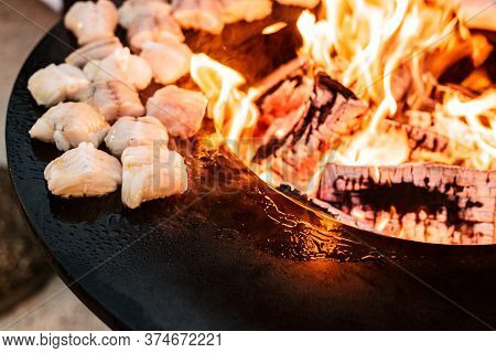 Fish Steaks Are Grilled. Close-up Of Pieces Of Fish. Round Grill Bowl, Round Roaster With A Fire In 