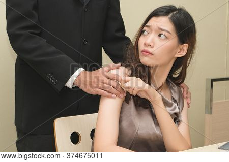 Sexsual Harassment In Workplace. Unhappy Female Employee Looking At Hand Of Boss Touch At Her Should