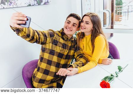 Cheerful Girl And Boy Testing New Phone Front Camera, Making Selfie.