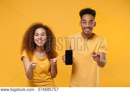 Smiling Friends Couple African American Guy Girl In Casual Clothes Isolated On Yellow Background. Pe