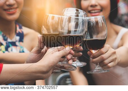 Happy Friends Enjoying  Xmas / New Year Party. Group Of Friends Cheering With Wines In The Fancy New