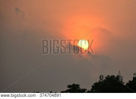 A Beautiful Sunset With Some Trees And Clear Sky
