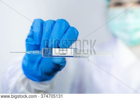 Doctor, Scientist, Researcher Hand In Blue Gloves Or Protective Suit Preparing For Human Clinical In