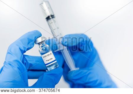 Doctor, Scientist, Researcher Hand In Blue Gloves Or Protective Suit Preparing For Human Clinical In