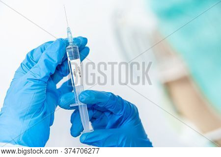Doctor, Scientist, Researcher Hand In Blue Gloves Or Protective Suit Preparing For Human Clinical In
