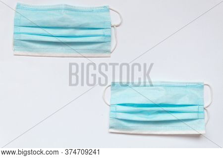 Two Blue Masks On A White Table