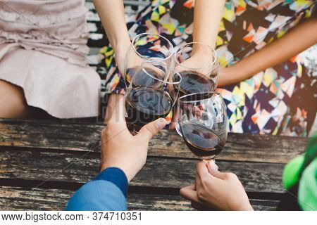 Happy Friends Enjoying  Xmas / New Year Party. Group Of Friends Cheering With Wines In The Fancy New