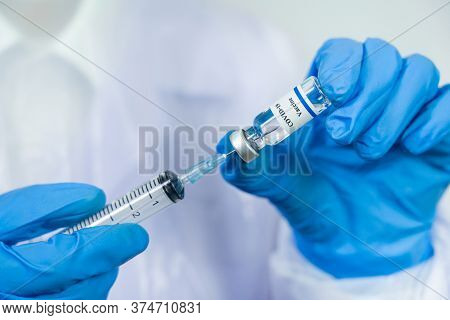 Doctor, Scientist, Researcher Hand In Blue Gloves Or Protective Suit Preparing For Human Clinical In