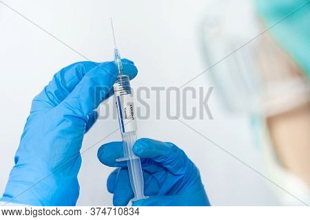 Doctor, Scientist, Researcher Hand In Blue Gloves Or Protective Suit Preparing For Human Clinical In