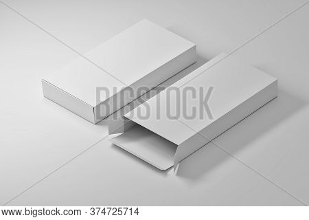 Isometric Arrangement Of Two Long Blank White Packaging Boxes On White Abckghpund. 3d Illustration.