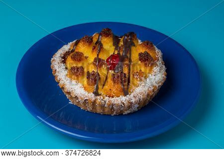 Coconut Cake On A Blue Plate On A Light Blue Background