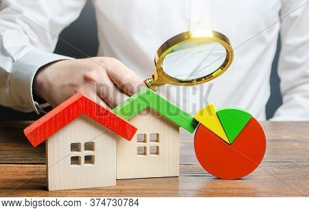 Man Is Studying The Structure Of Housing Costs With A Magnifying Glass. Revision Of Utility Bills An