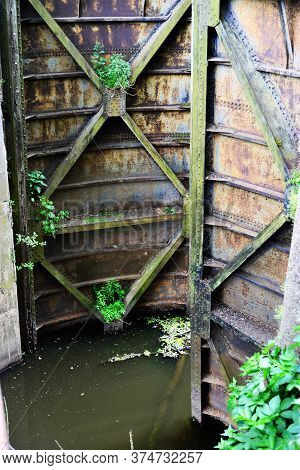 Old rusty floodgate
 gates abandoned anthropogenic landscape