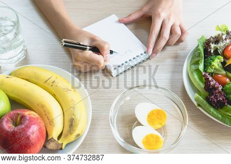 Dieting And Calories Control For Wellness. Woman Using Smartphone Calculate Calories Of Food In Brea