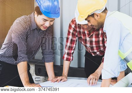 Concept Teamwork Of Building Construction Staff. Project Engineer / Contractor Reviewing Plan Of Wor