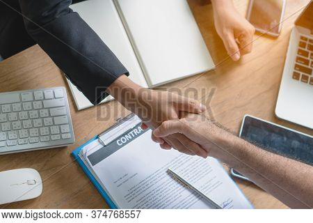 Business Partners Confirm Corporation. Young Startup Businessman Shaking Hands With Supplier / Clien