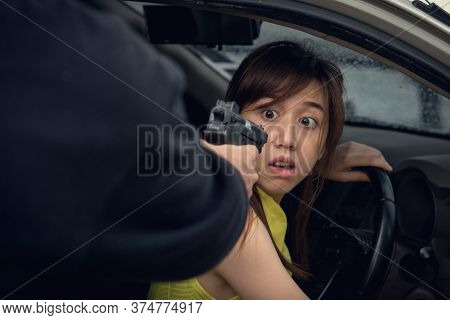 Dangerous In The City. Robber Pointing Gun To Victim In The Car And Try To Rob Mobile Phone From Her