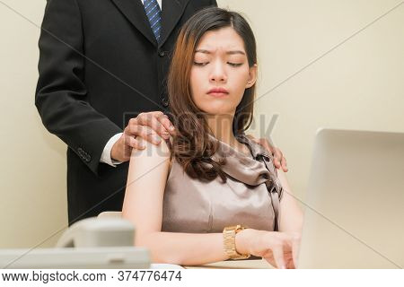 Sexsual Harassment In Workplace. Unhappy Female Employee Looking At Hand Of Boss Touch At Her Should