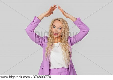 Life Insurance Policy. Happy Adult Woman With Curly Hair In A Business Suit Making A Gesture Of A Ho